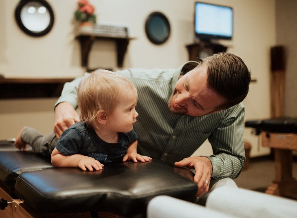 chiropractor speaking to small child