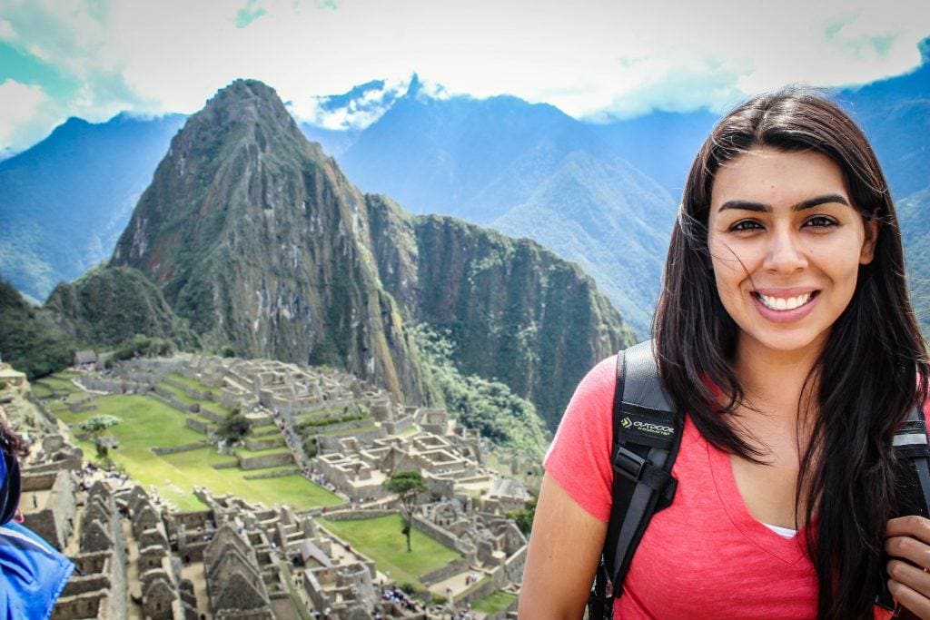 woman posing before architectural site