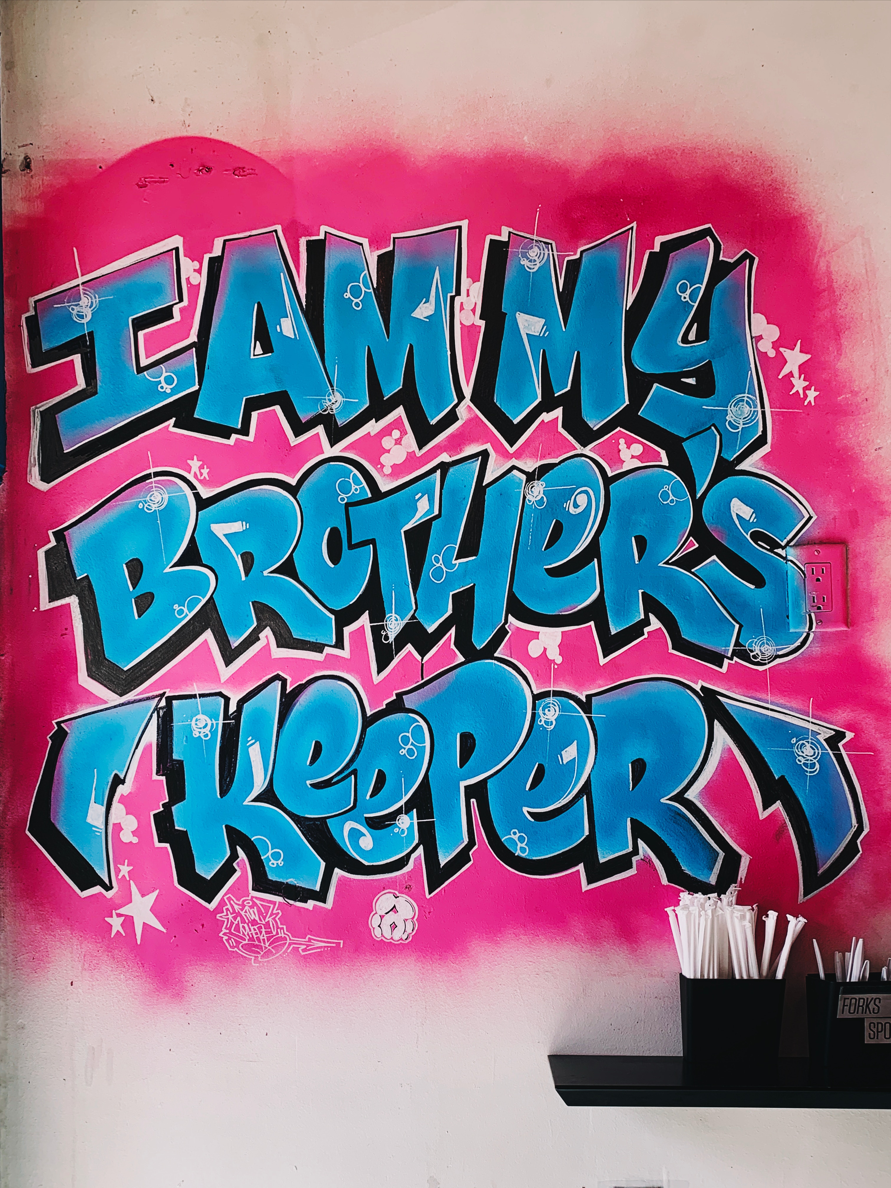 graffiti on wall saying I am my brother's keeping