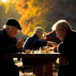 Older men playing chess in a park