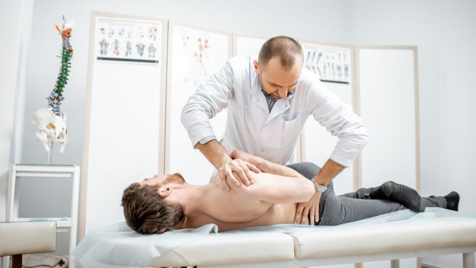 Chiropractor Performing Spinal Adjustment On A Patient