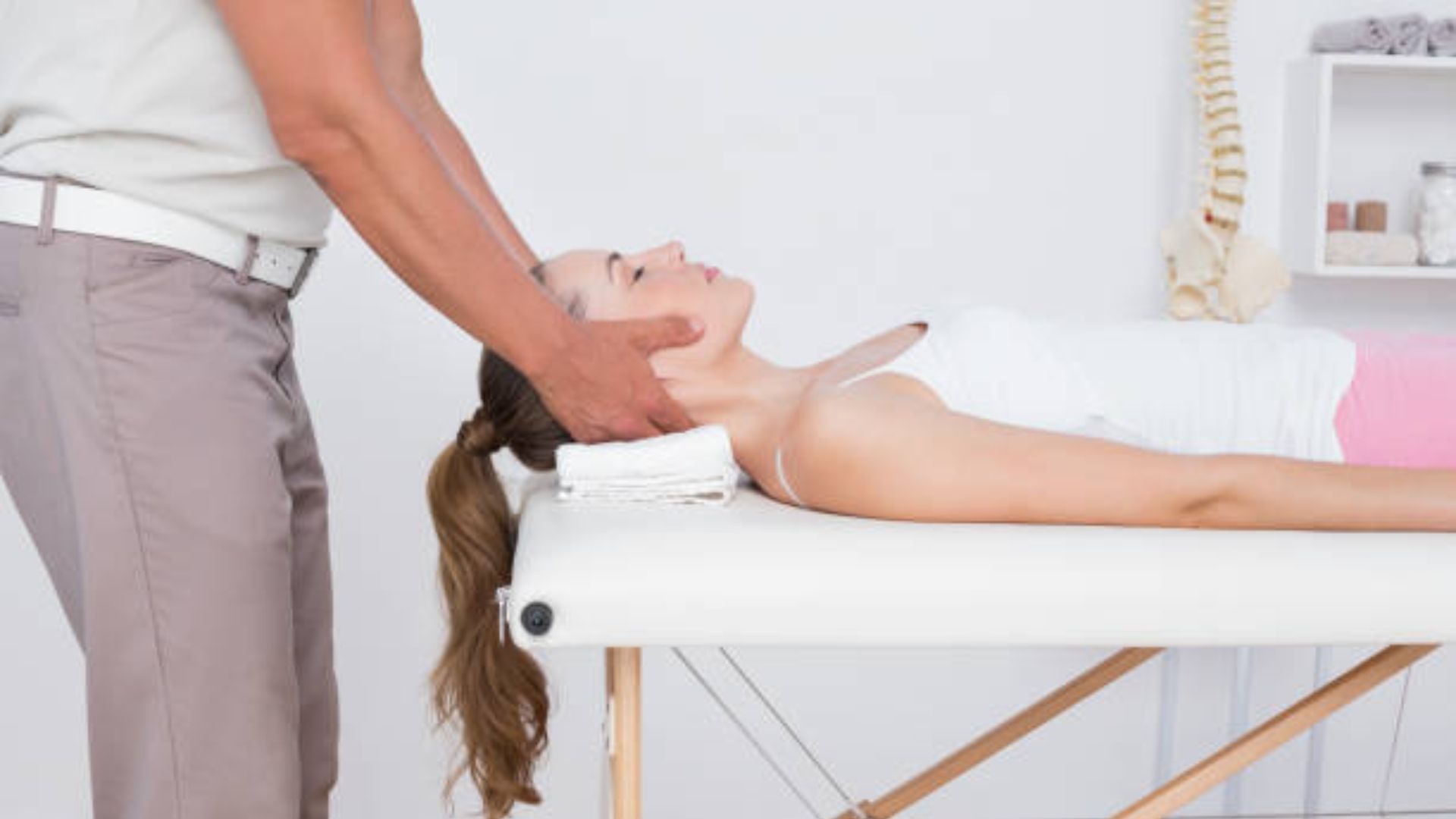 Chiropractor Performing A Neck Adjustment On A Patient