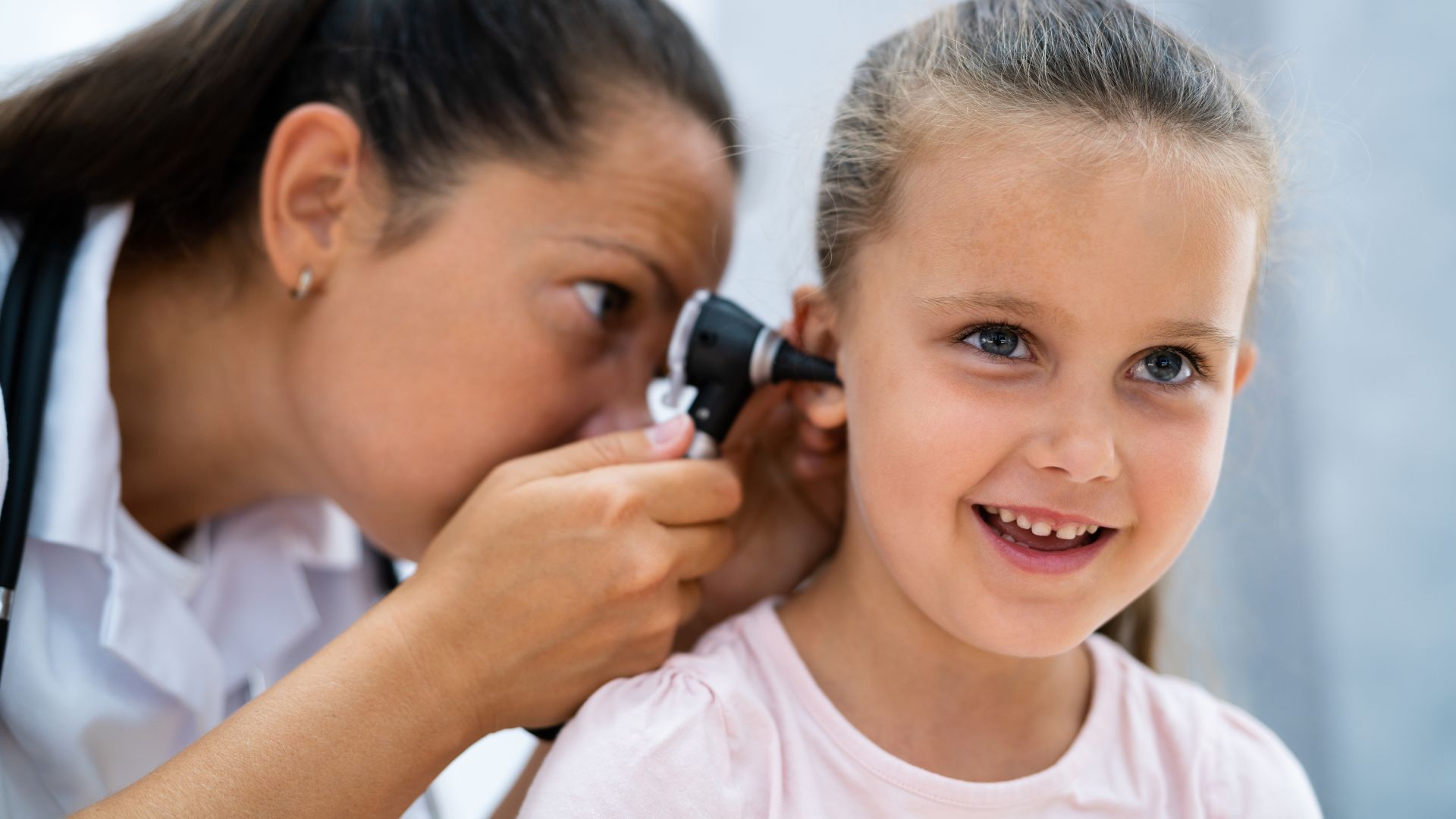 Doctor Using The Tool To Examine The Child's Ear