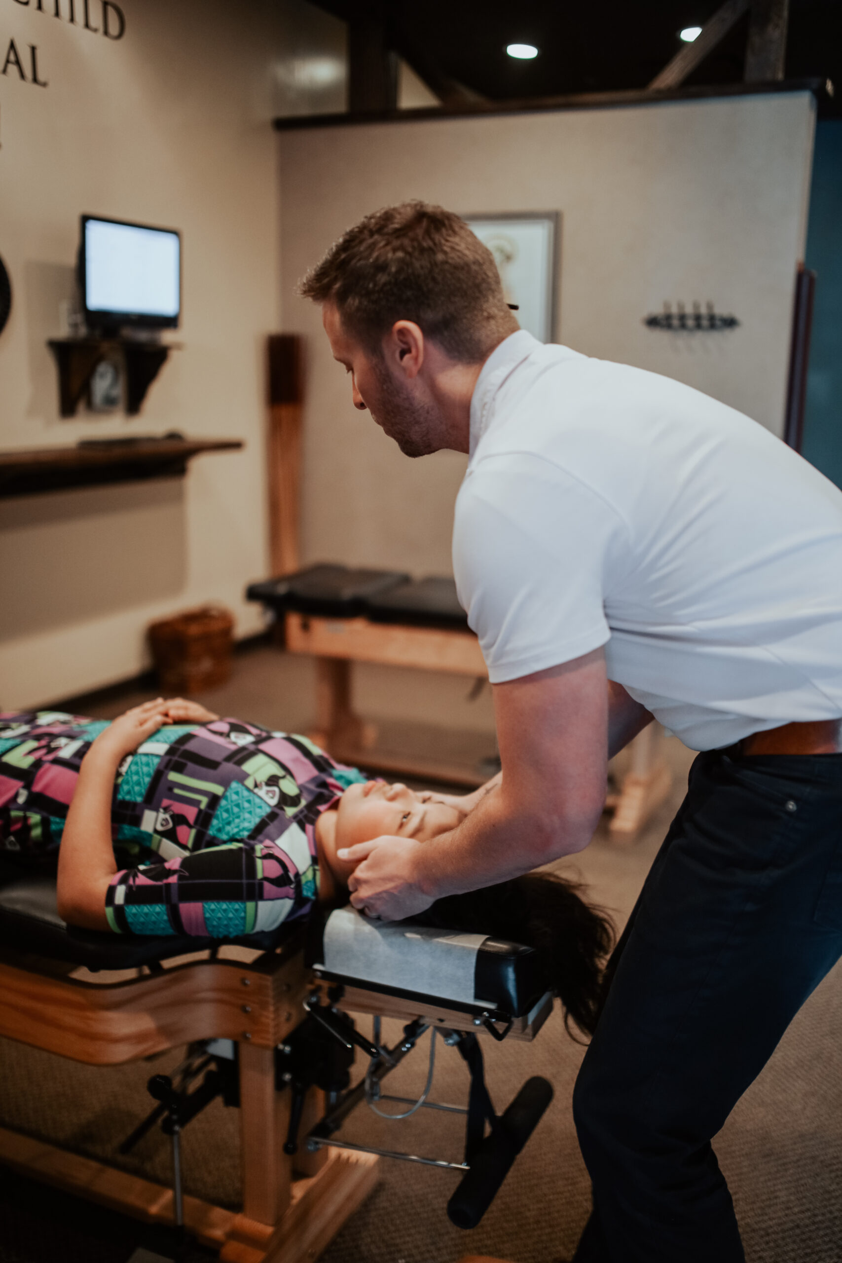 Chiropractor Treating A Patient On The Table