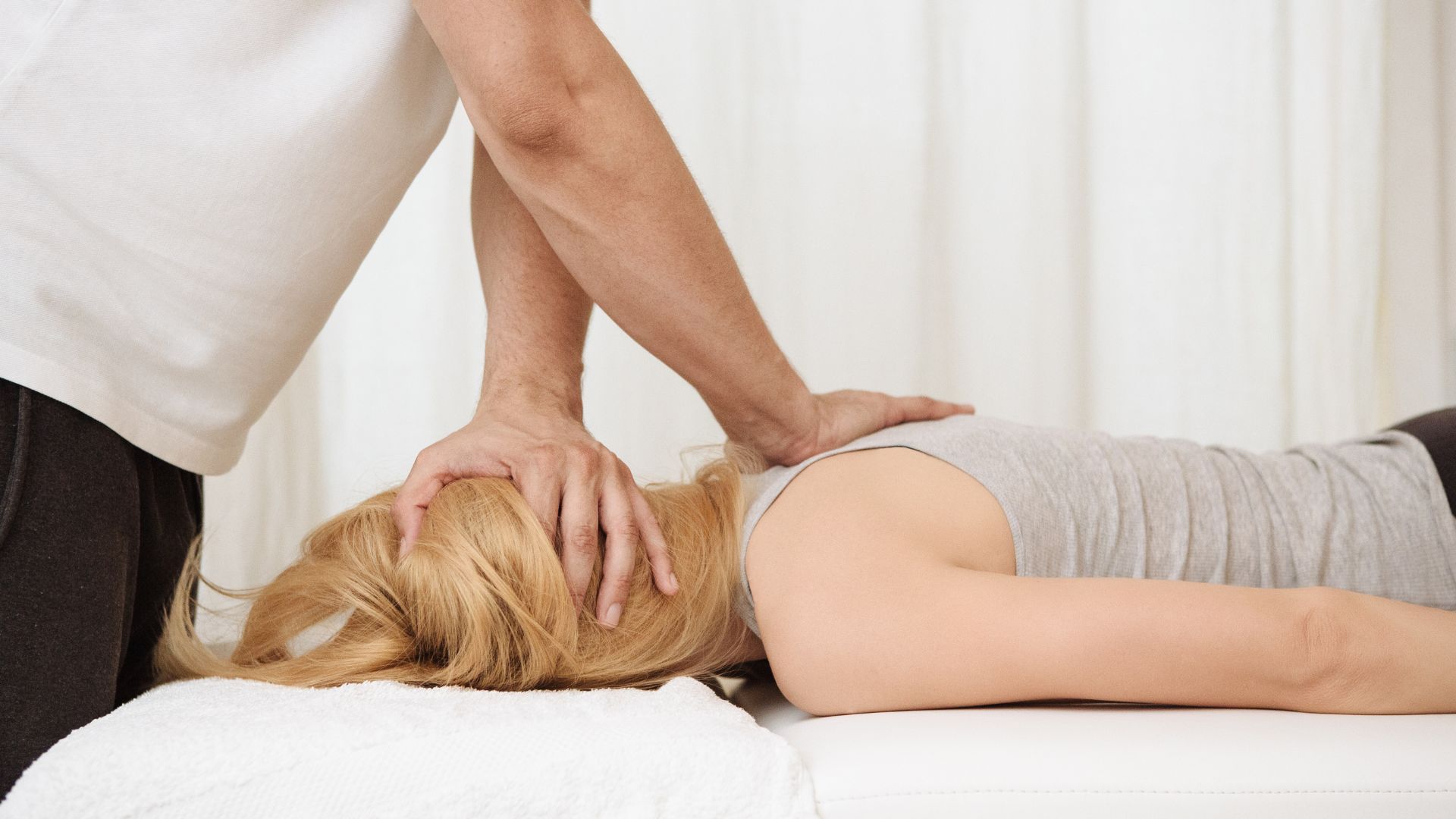 Chiropractor Adjusting A Woman's Back