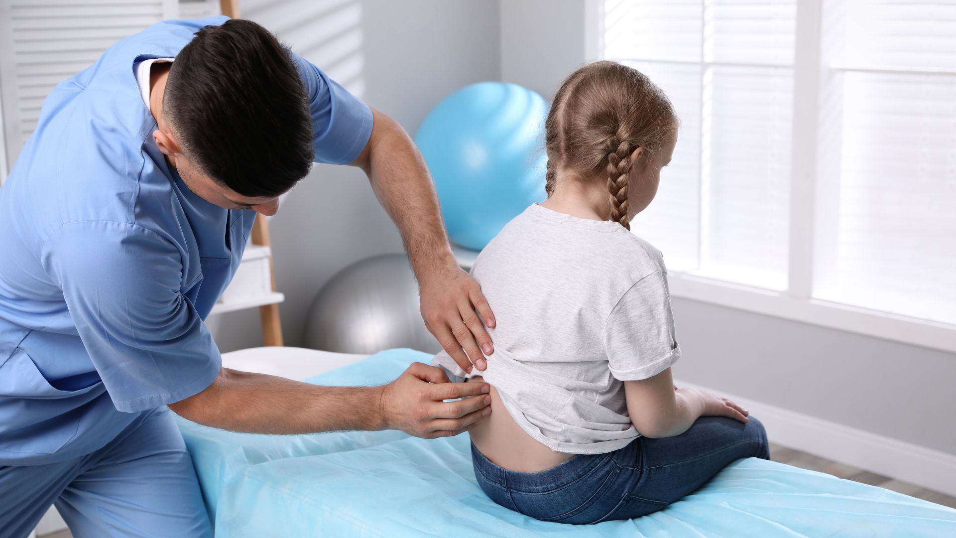 Expert Examining A Child's Back