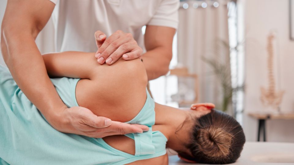 Chiropractor Adjusting A Patient's Back