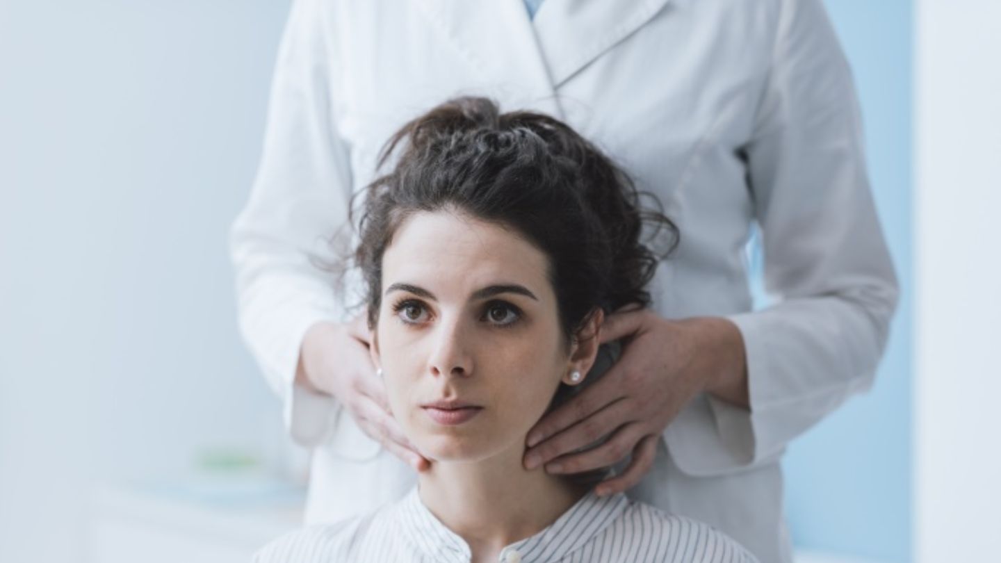 Chiropractor Examining A Woman's Neck