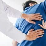 Chiropractor Checking Patient's Back