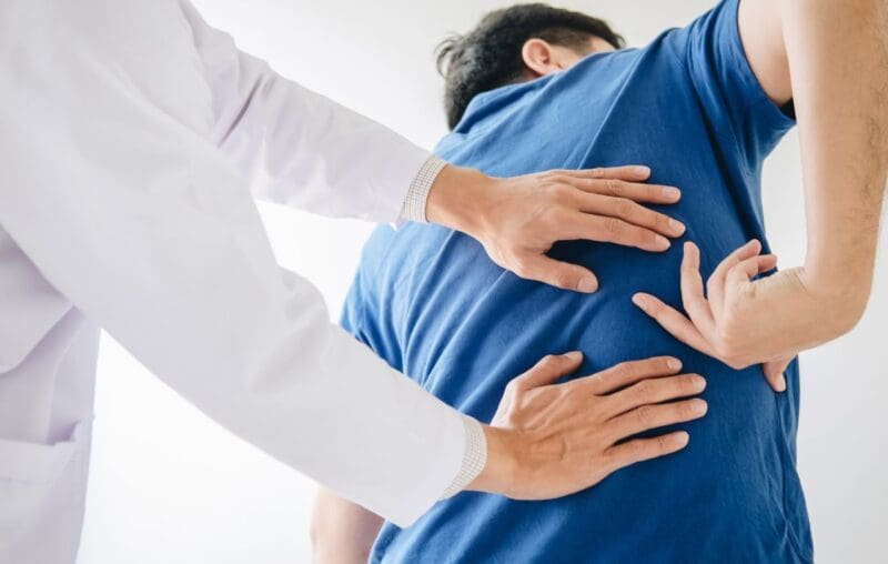 Chiropractor Checking Patient's Back