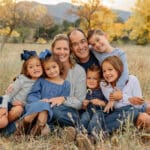 Large family of four children all snuggling and smiling for a portrait family session. Captured by Michelle Betz Photography