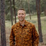 Dr. Ryan with Radix Chiropractics headshot. Surrounded by the forest.