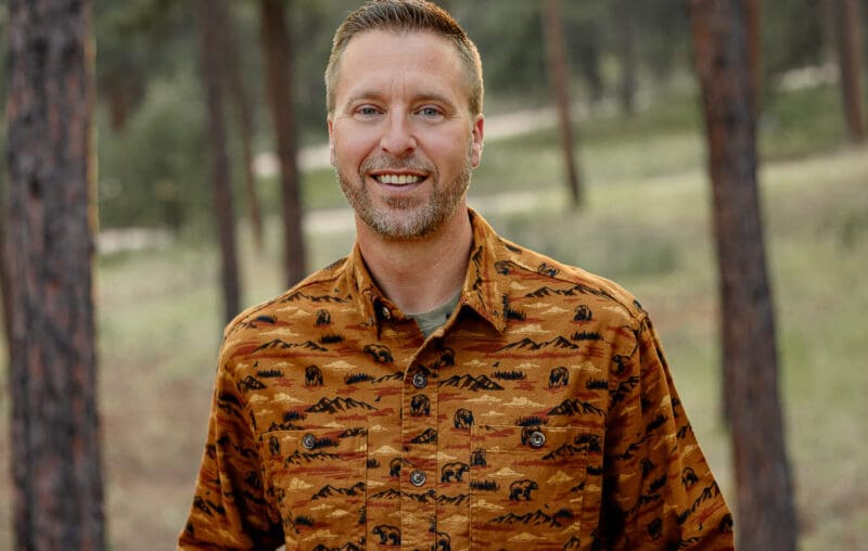 Dr. Ryan with Radix Chiropractics headshot. Surrounded by the forest.