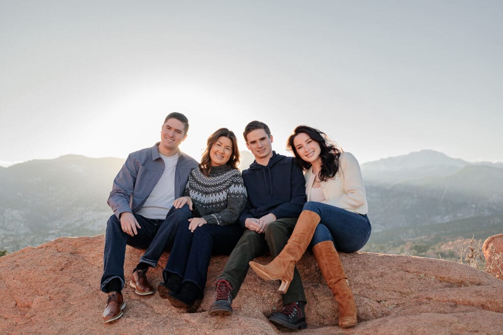 A family all smiling at the camera, surrounded by Garden of the Gods. They see Dr. Ryan Betz at Radix Chiropractic.